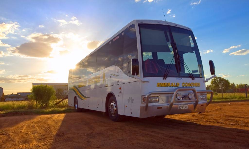 emerald coach bus at sunset